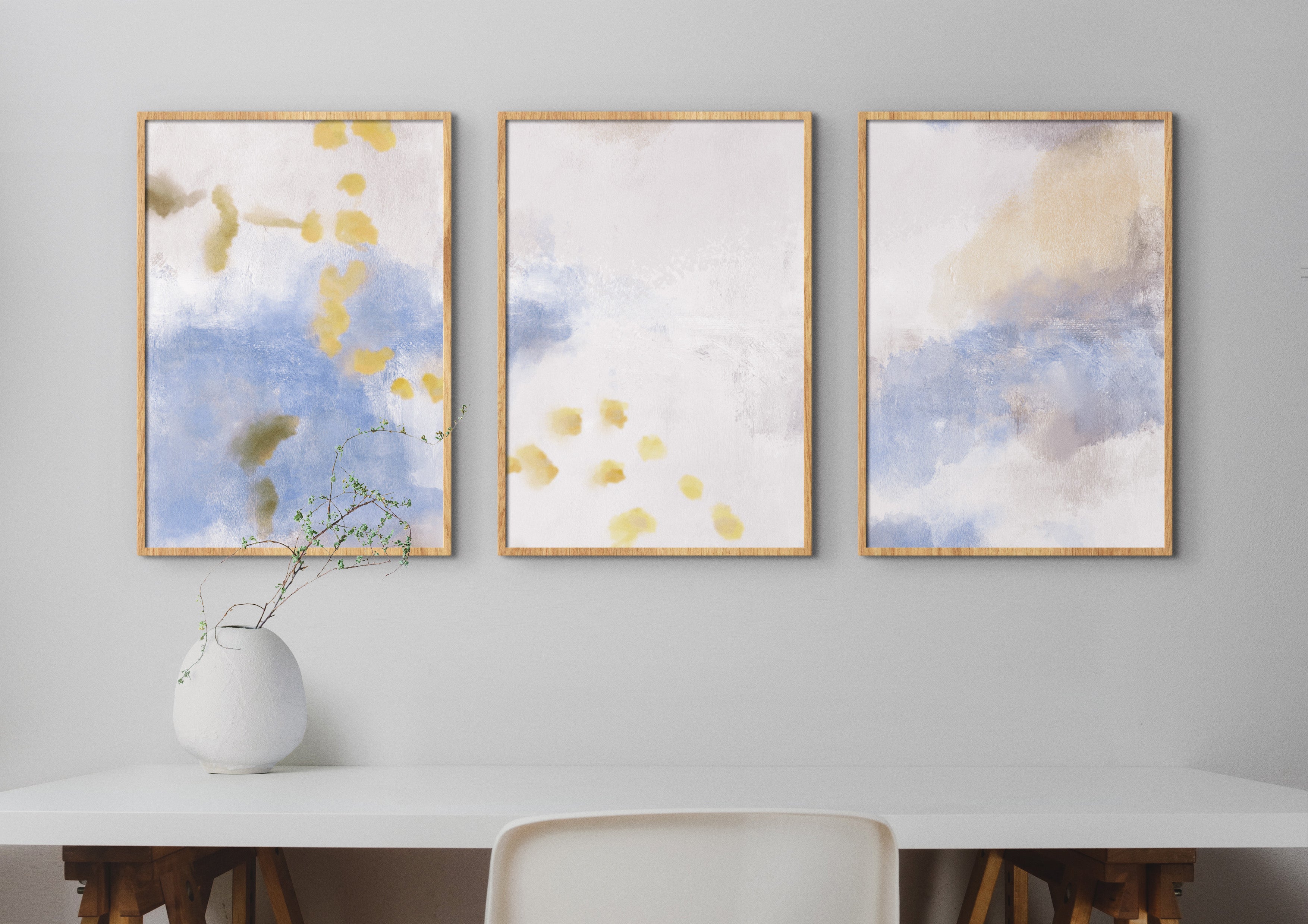 A Study in Gold triptych framed fine art print set, featuring soft golden, blue, and neutral brushstrokes, printed on museum-quality paper and framed in oak, ready to hang.