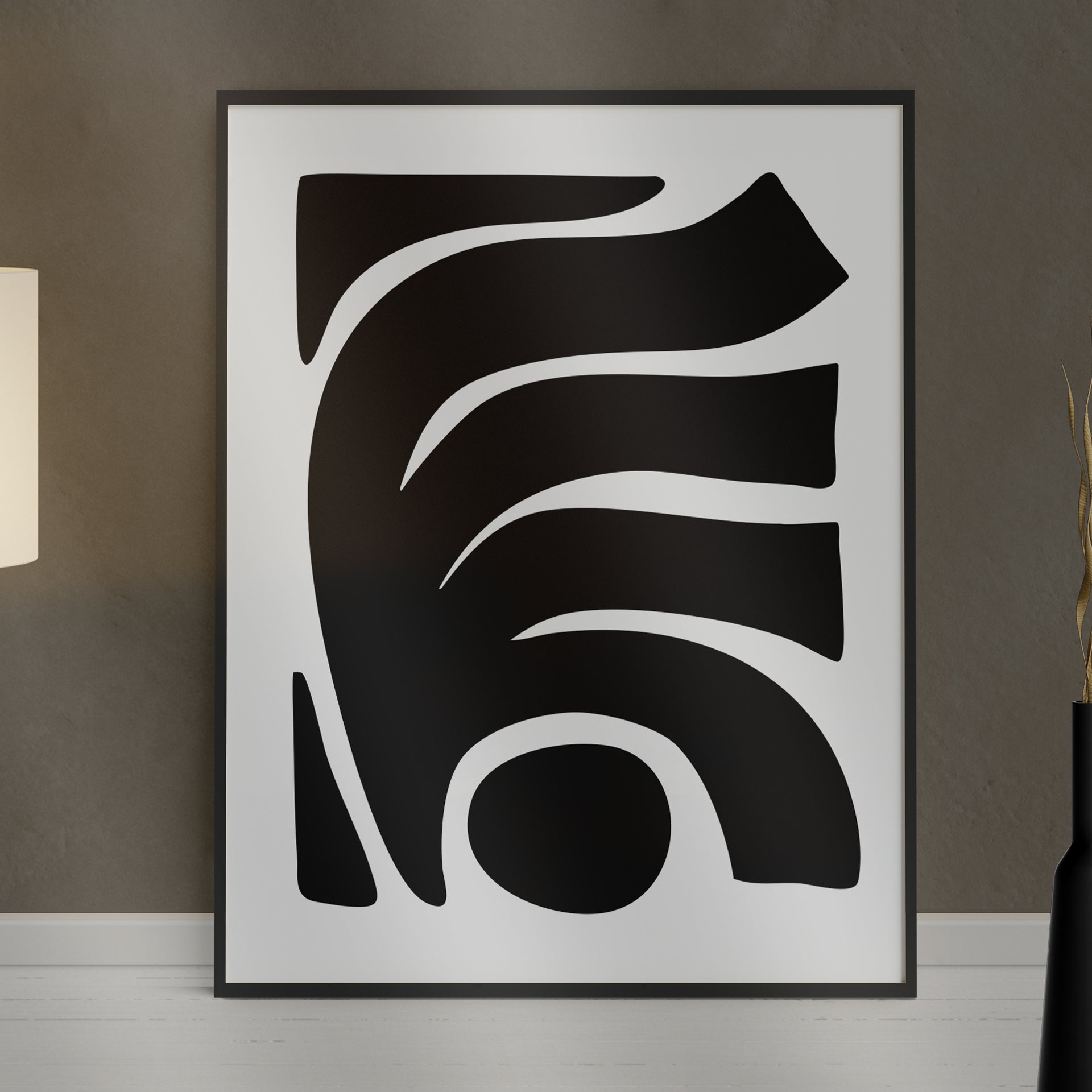 Besma 1 luxury modern abstract art print – museum-quality framed artwork for contemporary interiors. Shown as a print in black frame sitting against a wall with lamp and vase in foreground.