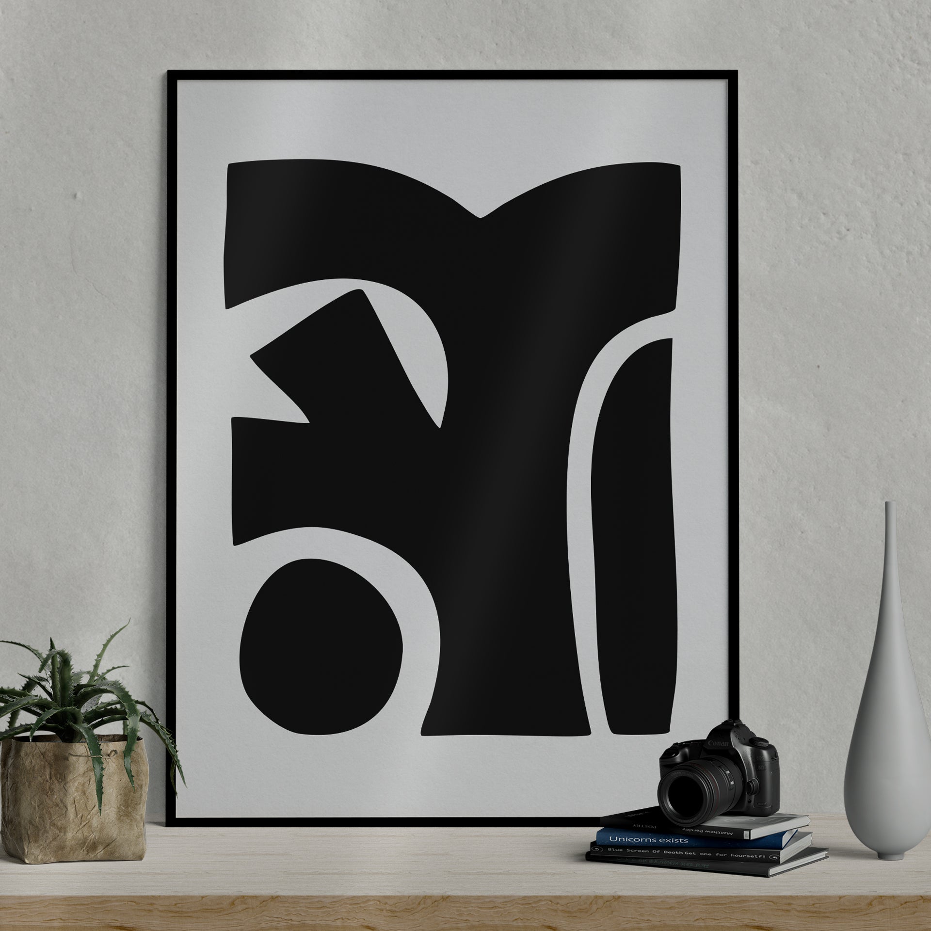 Besma 4 luxury modern abstract art print – museum-quality framed artwork for contemporary interiors. Shown as a print in black frame sitting against a wall with lamp and vase in foreground.