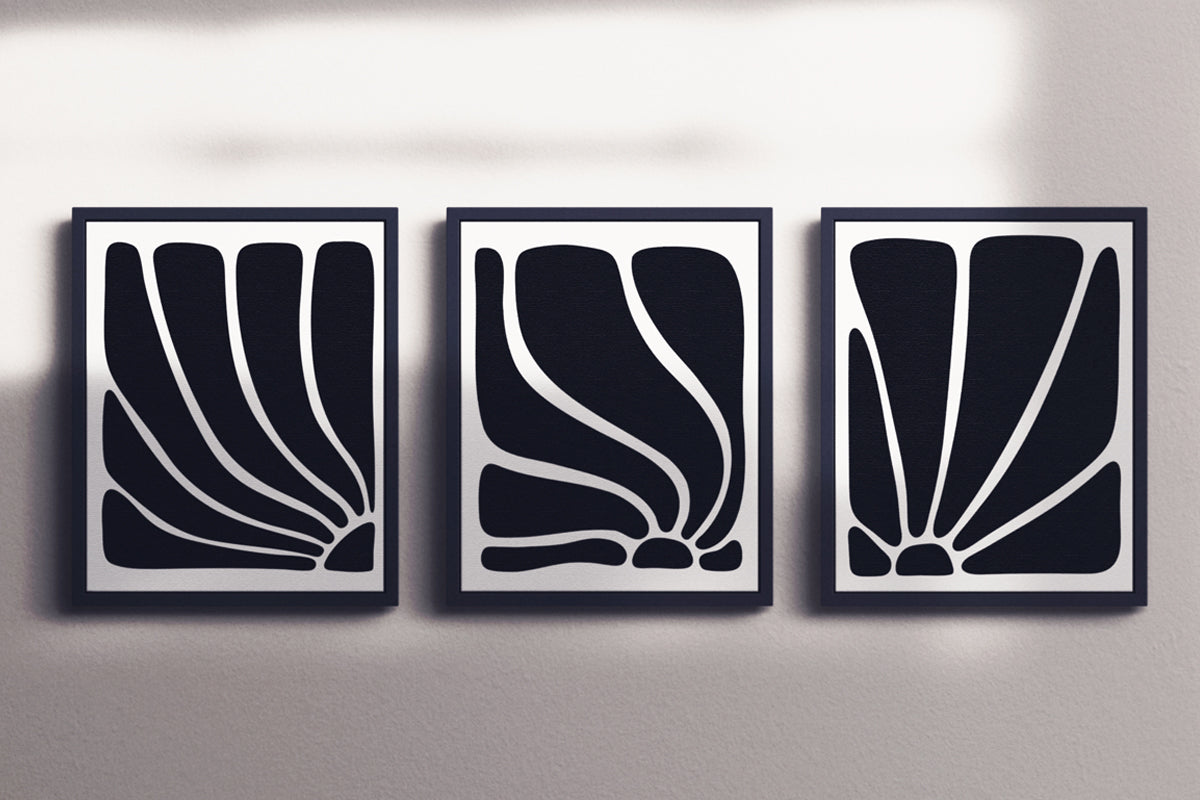Black & White Flow – Luxury minimalist abstract art print in black and white, museum-quality framed artwork. Shown as a multi-panel triptych set in black frames on white wall with overlaying shadows.